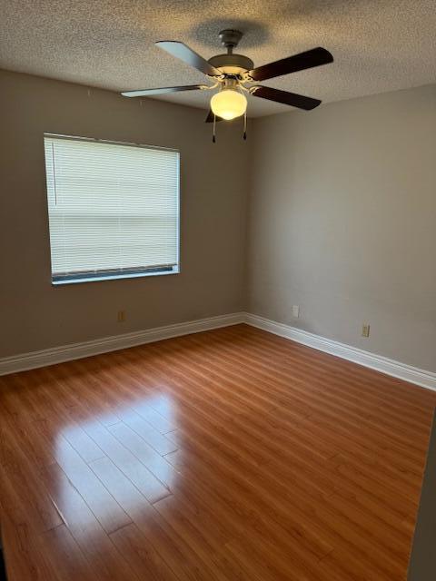 6014 Indrio Road, Unit F2 Fort Pierce, FL 34951 - Photo 9 of 27 a view of an empty room with wooden floor and a window