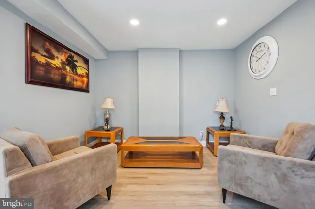 a living room with furniture and a wall painting