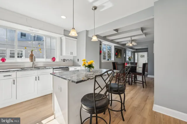 a kitchen with stainless steel appliances granite countertop sink stove top oven and cabinets