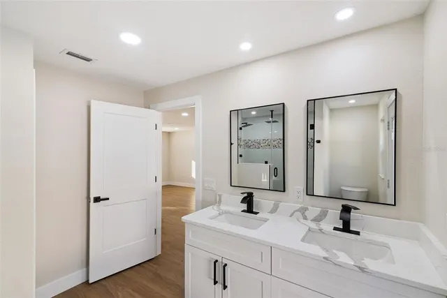 a bedroom with a bed and a ceiling fan