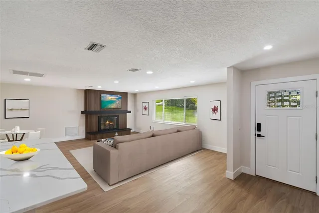 a living room with furniture and a wooden floor
