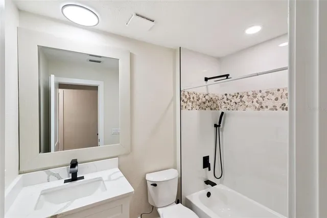 a view of a livingroom with a ceiling fan and window