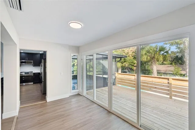 a view of a backyard with a large tree and wooden fence