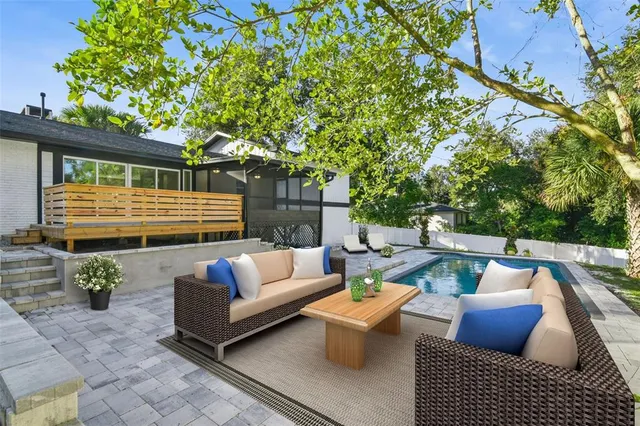 an aerial view of residential houses with outdoor space and trees