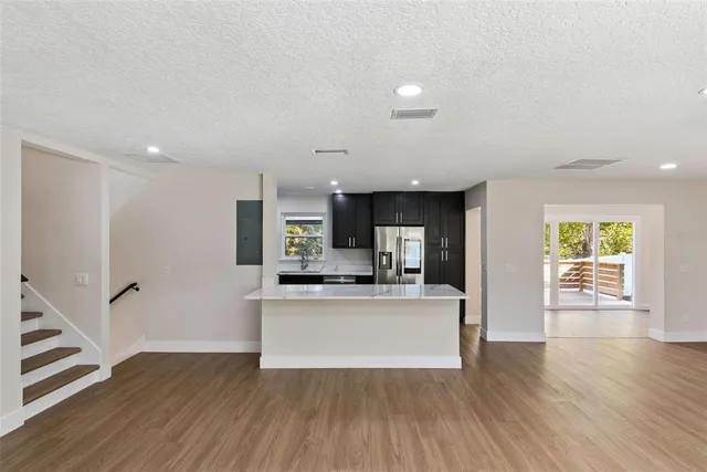 a kitchen with stainless steel appliances granite countertop a sink stove and refrigerator