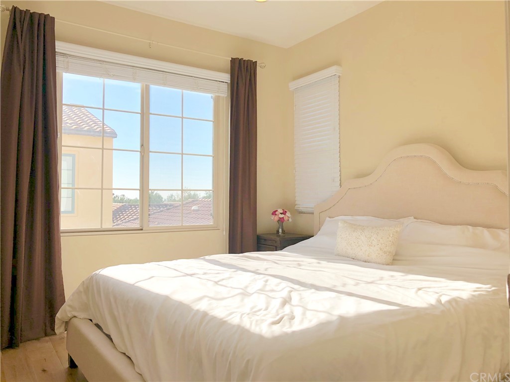 222 Firefly Irvine, CA 92618 - Photo 18 of 26 a bedroom with a bed and a large window