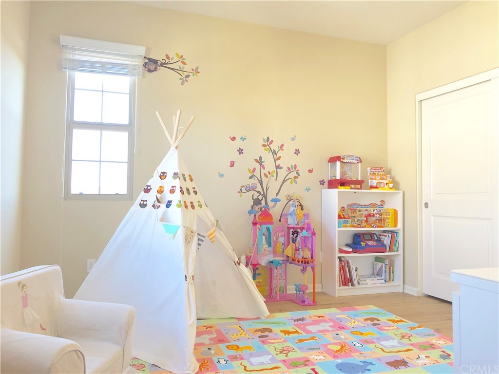 222 Firefly Irvine, CA 92618 - Photo 22 of 26 a living room with baby crib furniture and a rug