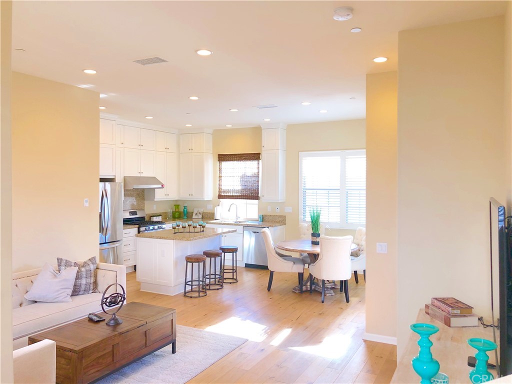 222 Firefly Irvine, CA 92618 - Photo 25 of 26 a living room with furniture and a dining table with kitchen view