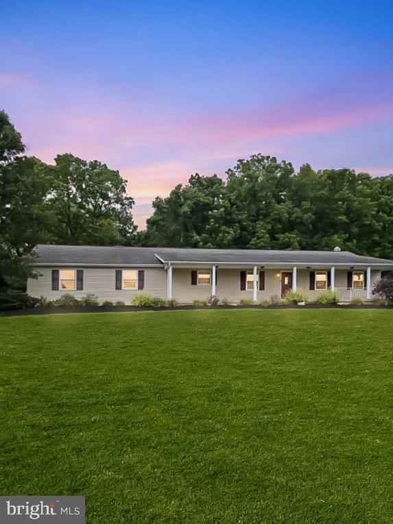 129 Walker Drive Spring Mills, PA 16875 - Photo 1 of 29 a front view of a house with a garden