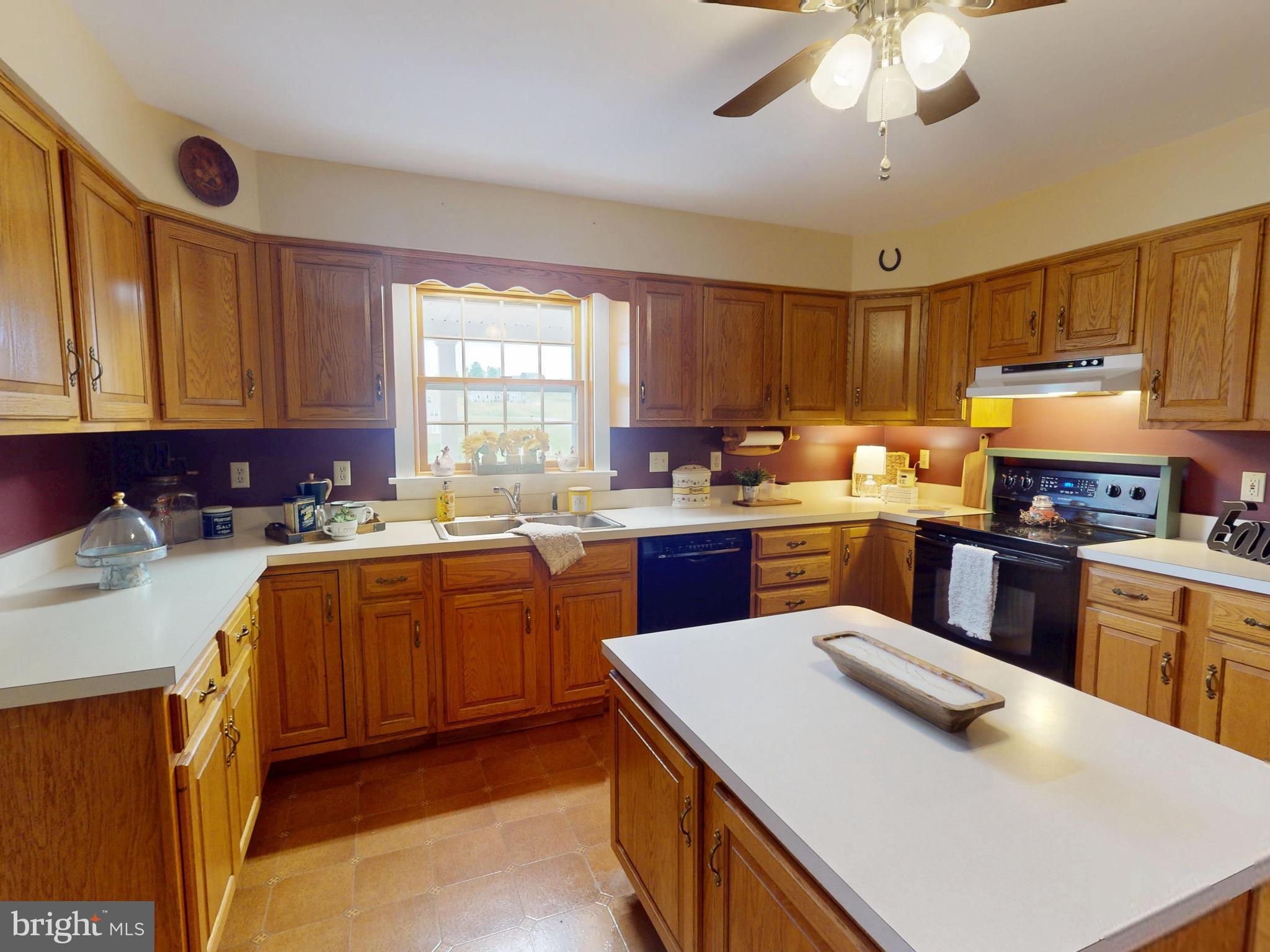 129 Walker Drive Spring Mills, PA 16875 - Photo 11 of 29 a kitchen with a stove a sink a refrigerator and cabinets