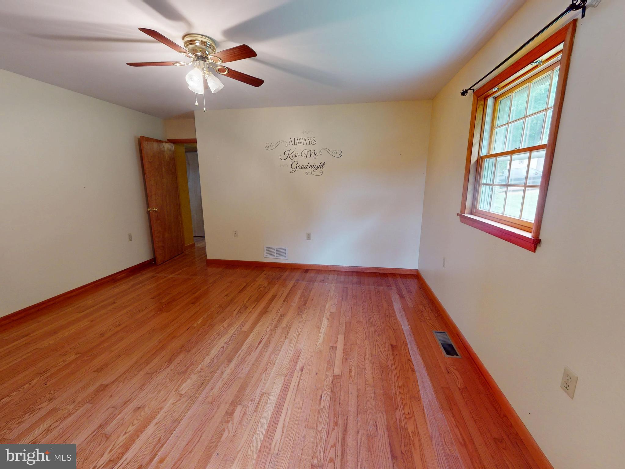129 Walker Drive Spring Mills, PA 16875 - Photo 12 of 29 an empty room with wooden floor chandelier fan and windows