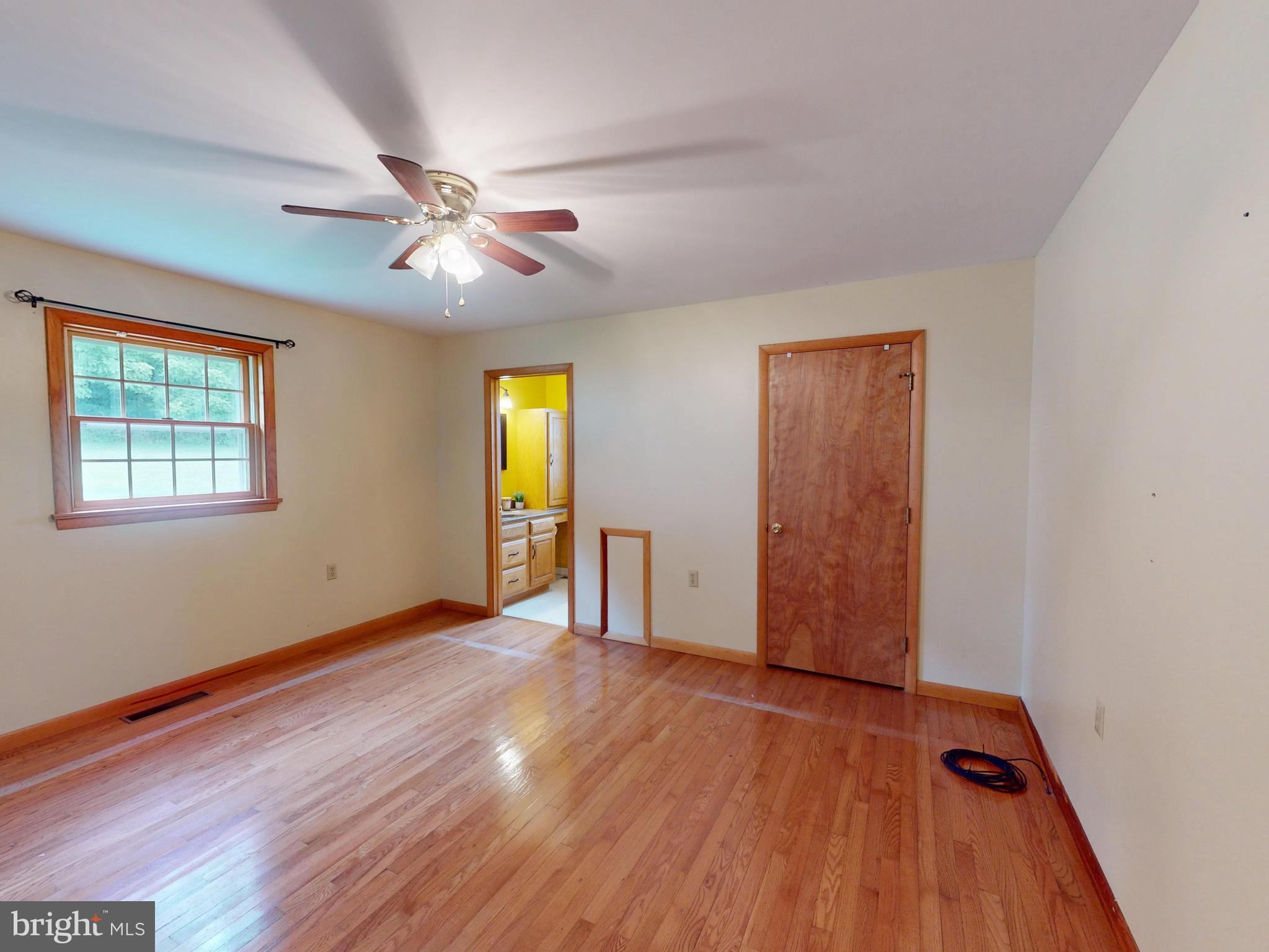 129 Walker Drive Spring Mills, PA 16875 - Photo 13 of 29 an empty room with wooden floor chandelier fan and windows