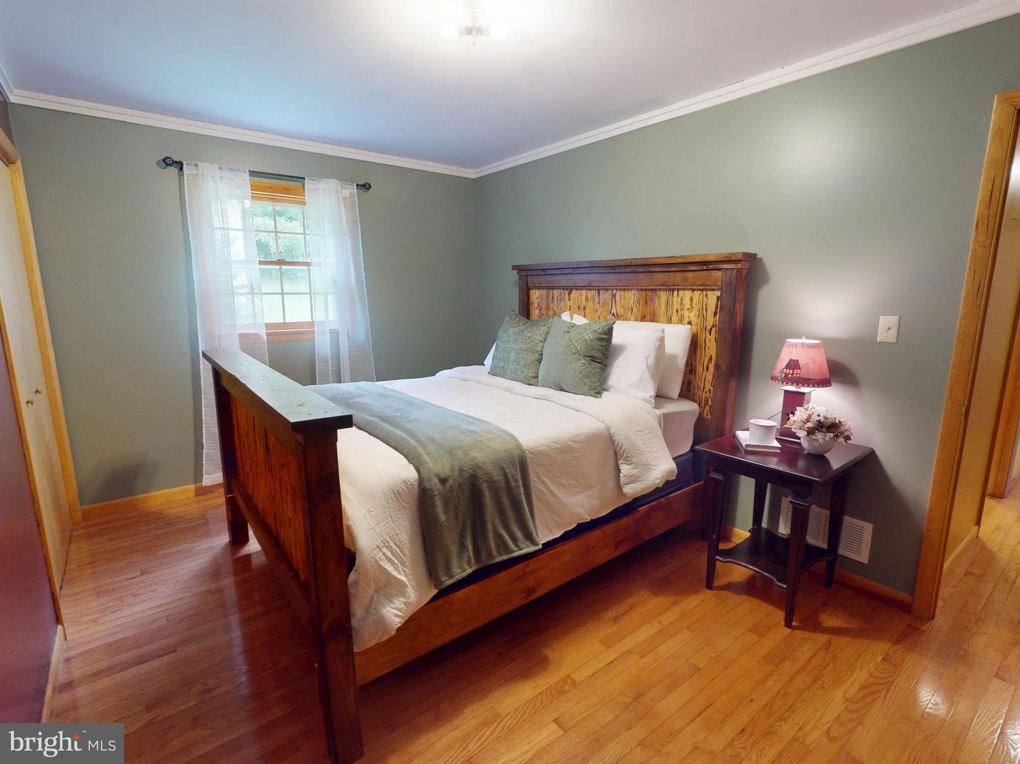 129 Walker Drive Spring Mills, PA 16875 - Photo 16 of 29 a bedroom with a bed and wooden floor