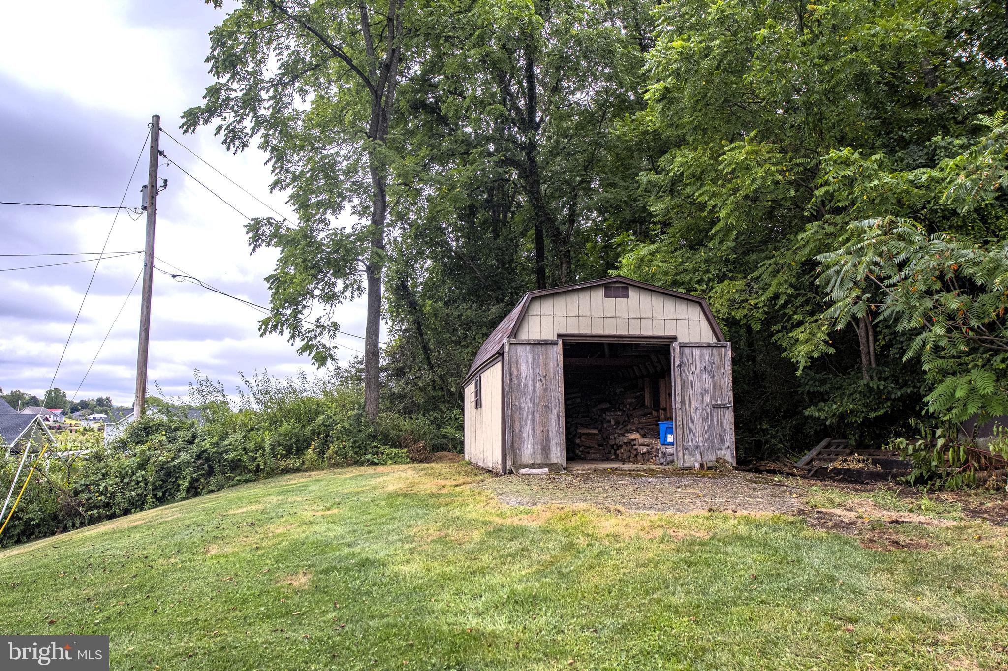 129 Walker Drive Spring Mills, PA 16875 - Photo 26 of 29 a view of a barn in the middle of a yard