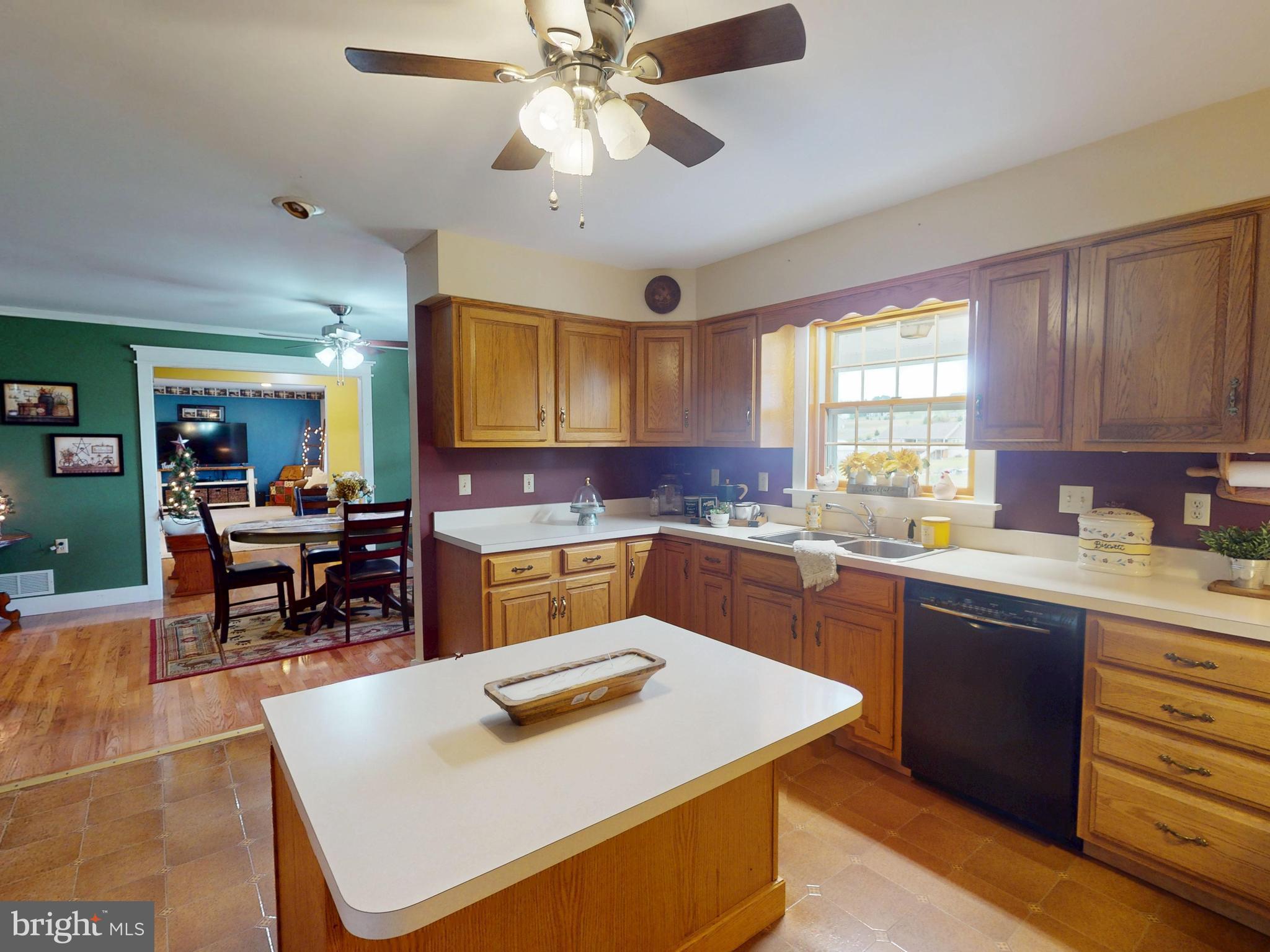 129 Walker Drive Spring Mills, PA 16875 - Photo 9 of 29 a kitchen with a stove a sink a dining table and chairs