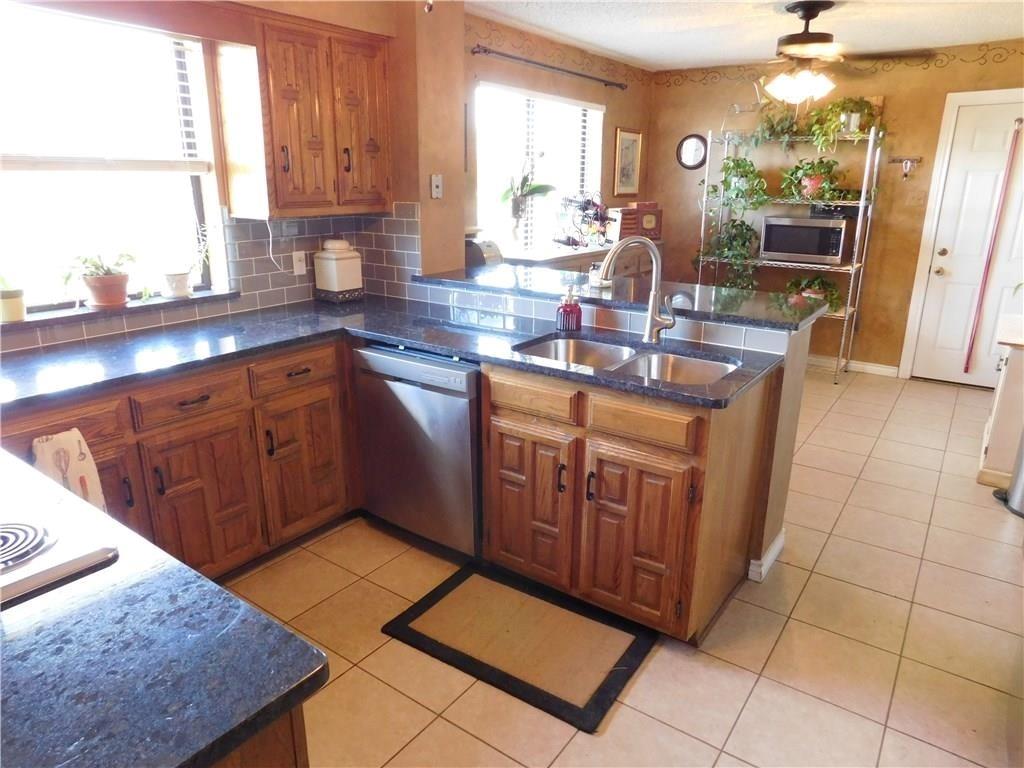 410 Barnes Bridge Road Sunnyvale, TX 75182 - Photo 11 of 20 a kitchen with stainless steel appliances granite countertop a sink counter space cabinets and a window