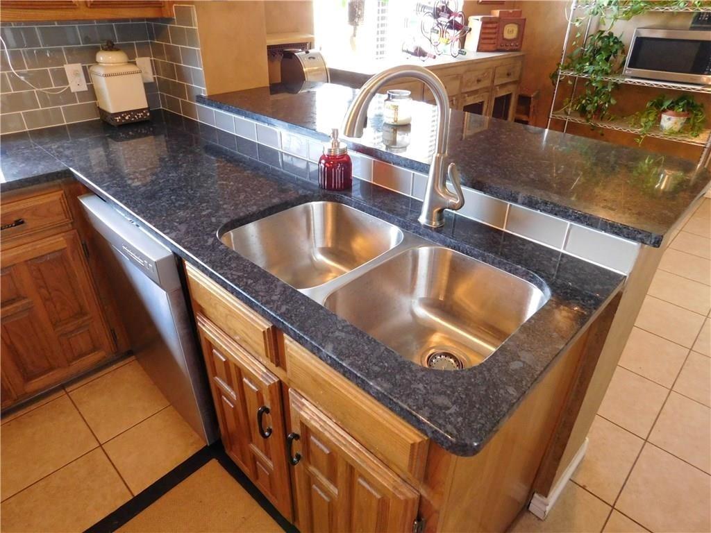 410 Barnes Bridge Road Sunnyvale, TX 75182 - Photo 12 of 20 a kitchen with a sink a counter top space and cabinets