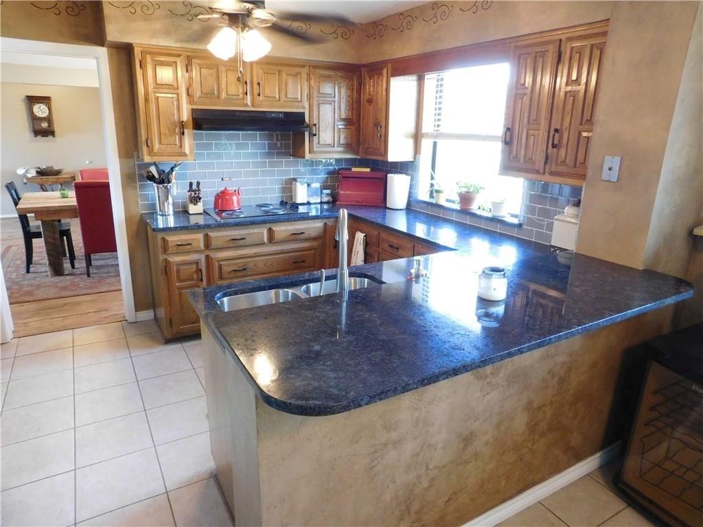 410 Barnes Bridge Road Sunnyvale, TX 75182 - Photo 10 of 20 a kitchen with stainless steel appliances granite countertop a sink dishwasher and a refrigerator with the countertops