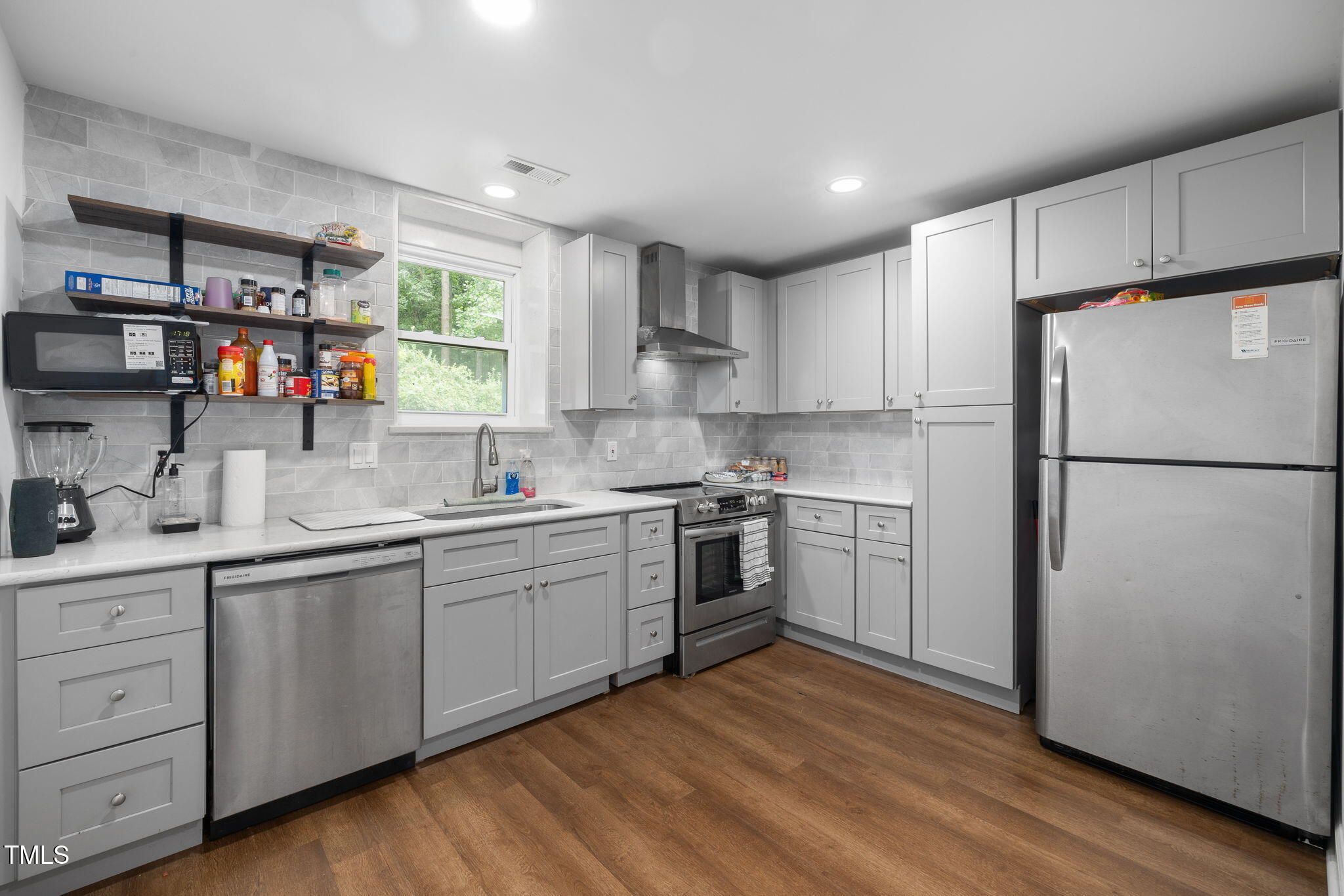 1319 Legend Road Raleigh, NC 27603 - Photo 23 of 38 a kitchen with a sink cabinets stainless steel appliances and a window