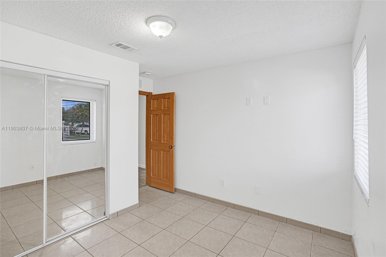 11482 Southwest 181st Street Miami, FL 33157 - Photo 15 of 35 an empty room with closet