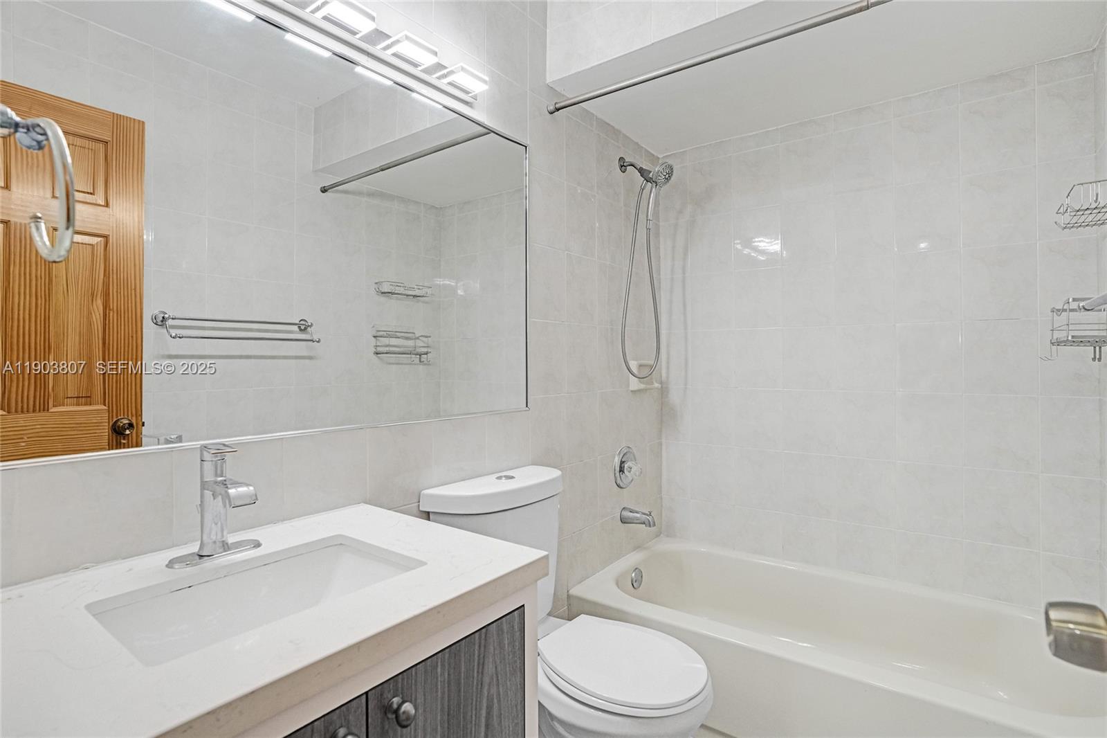 11482 Southwest 181st Street Miami, FL 33157 - Photo 16 of 35 a bathroom with a sink mirror toilet and bathtub