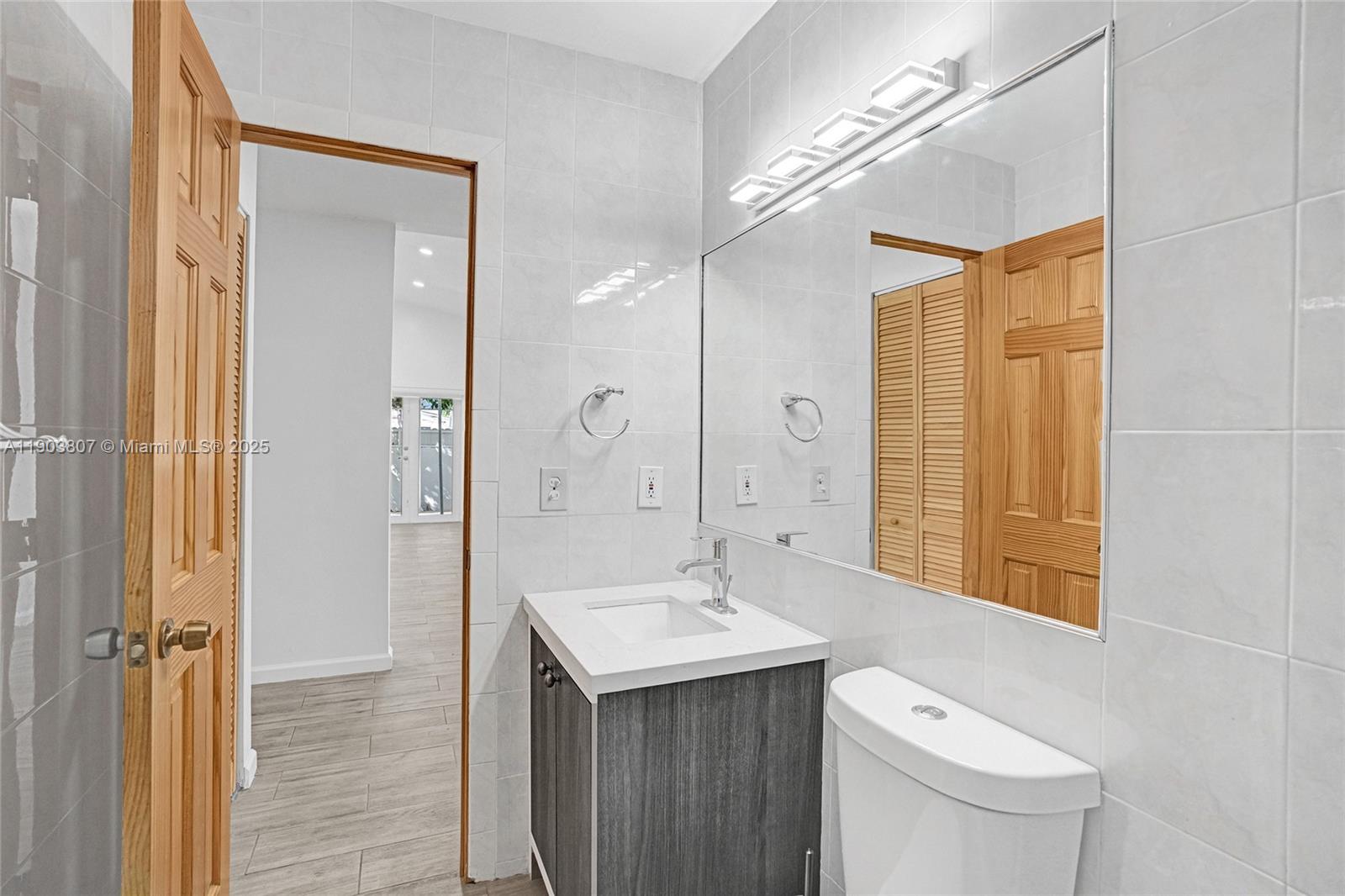 11482 Southwest 181st Street Miami, FL 33157 - Photo 17 of 35 a bathroom with a sink a toilet and shower