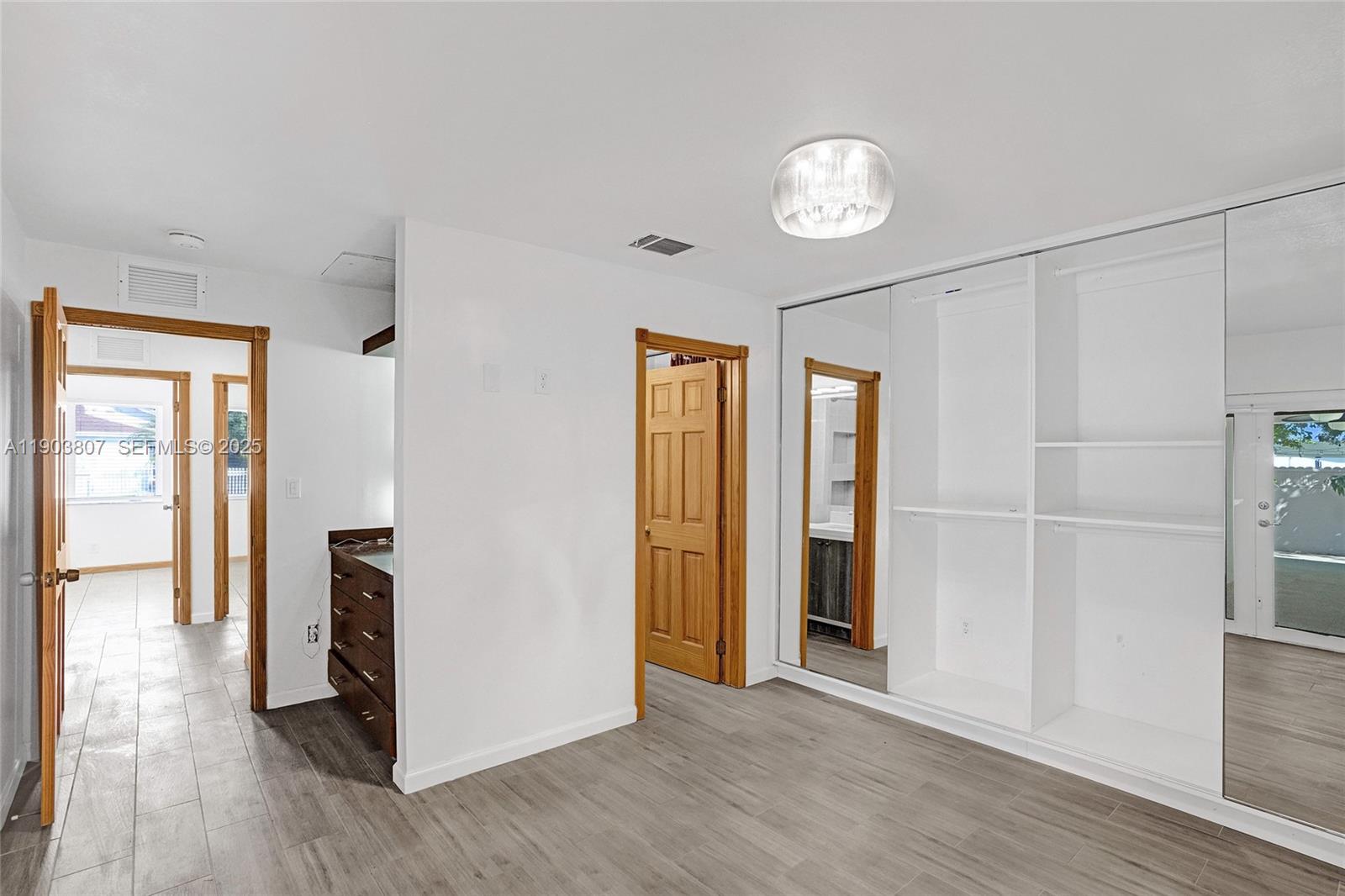 11482 Southwest 181st Street Miami, FL 33157 - Photo 20 of 35 a view of empty room with wooden floor and window