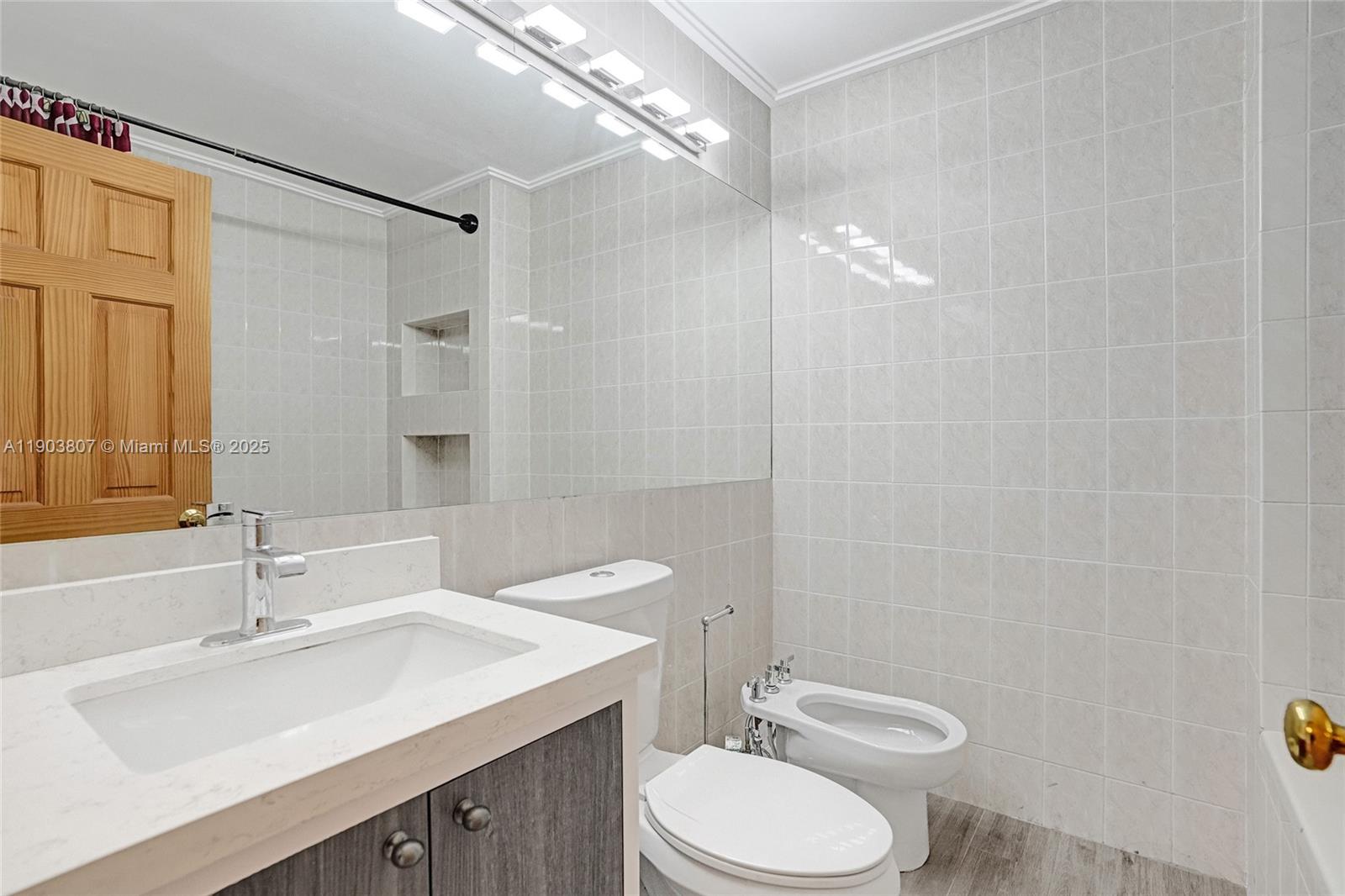 11482 Southwest 181st Street Miami, FL 33157 - Photo 21 of 35 a bathroom with a sink a toilet a mirror and shower