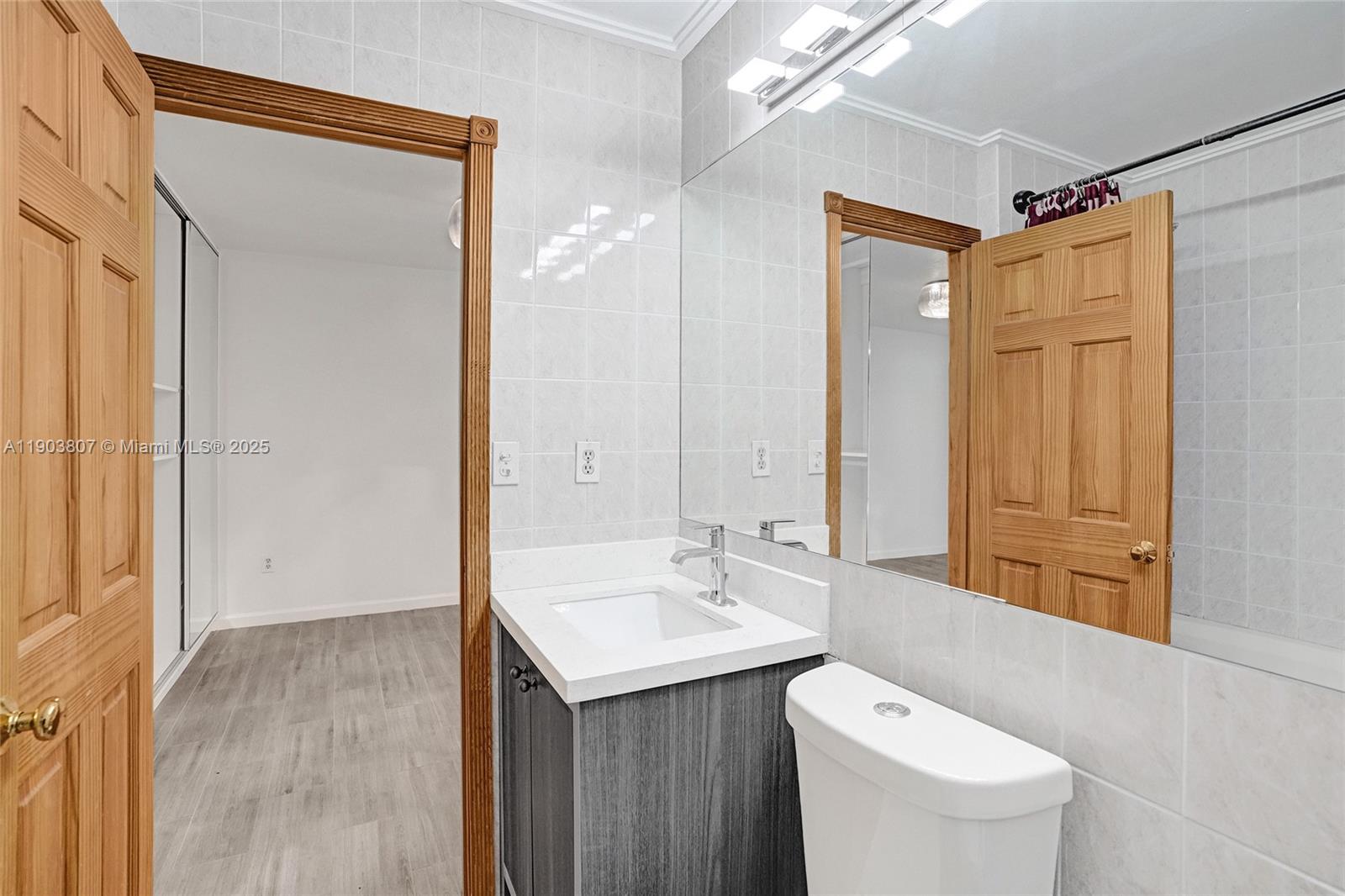 11482 Southwest 181st Street Miami, FL 33157 - Photo 23 of 35 a bathroom with a toilet a sink and mirror