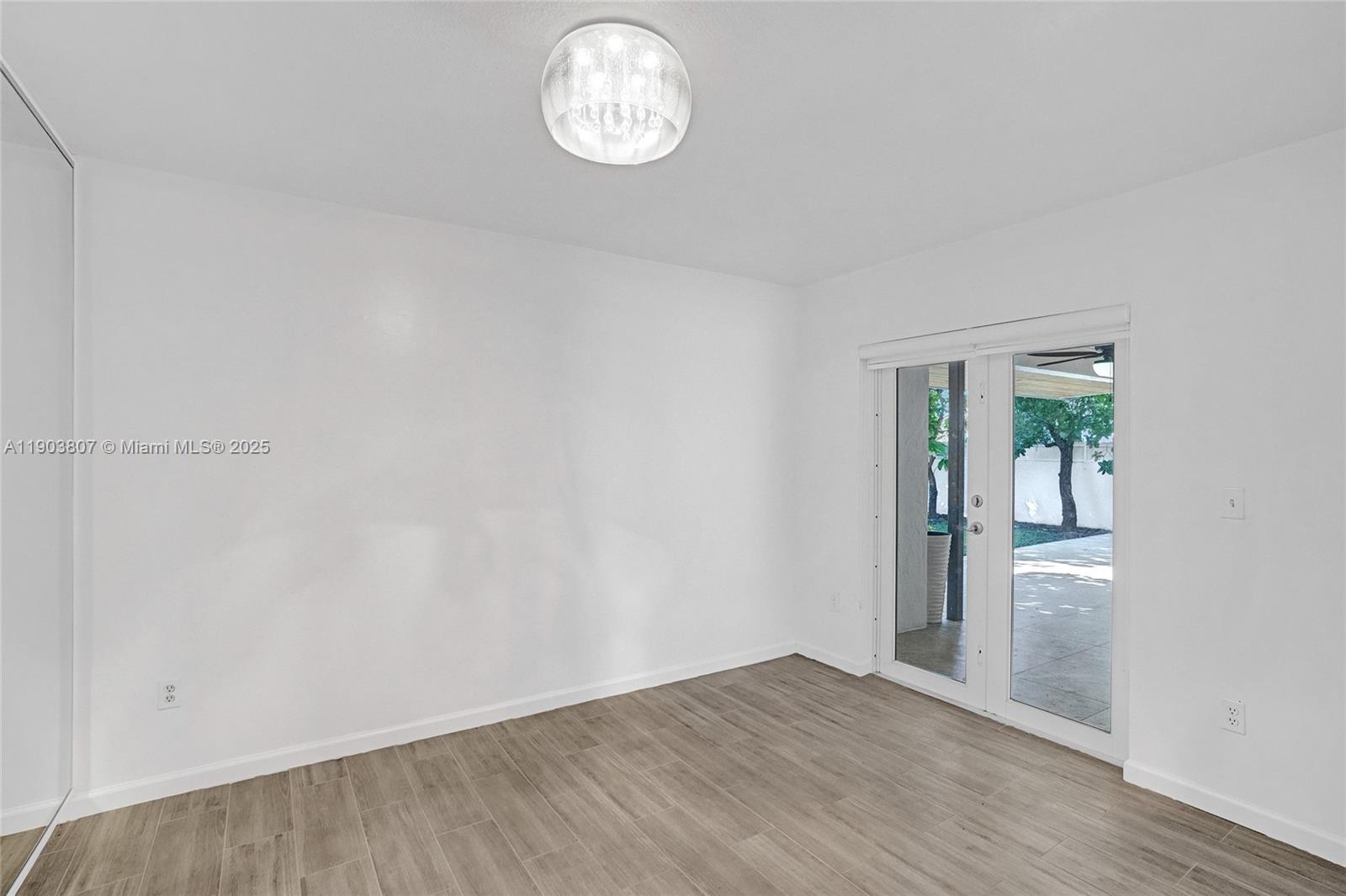 11482 Southwest 181st Street Miami, FL 33157 - Photo 24 of 35 an empty room with wooden floor and windows