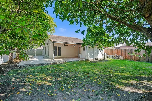 a view of a house with backyard sitting area and garden