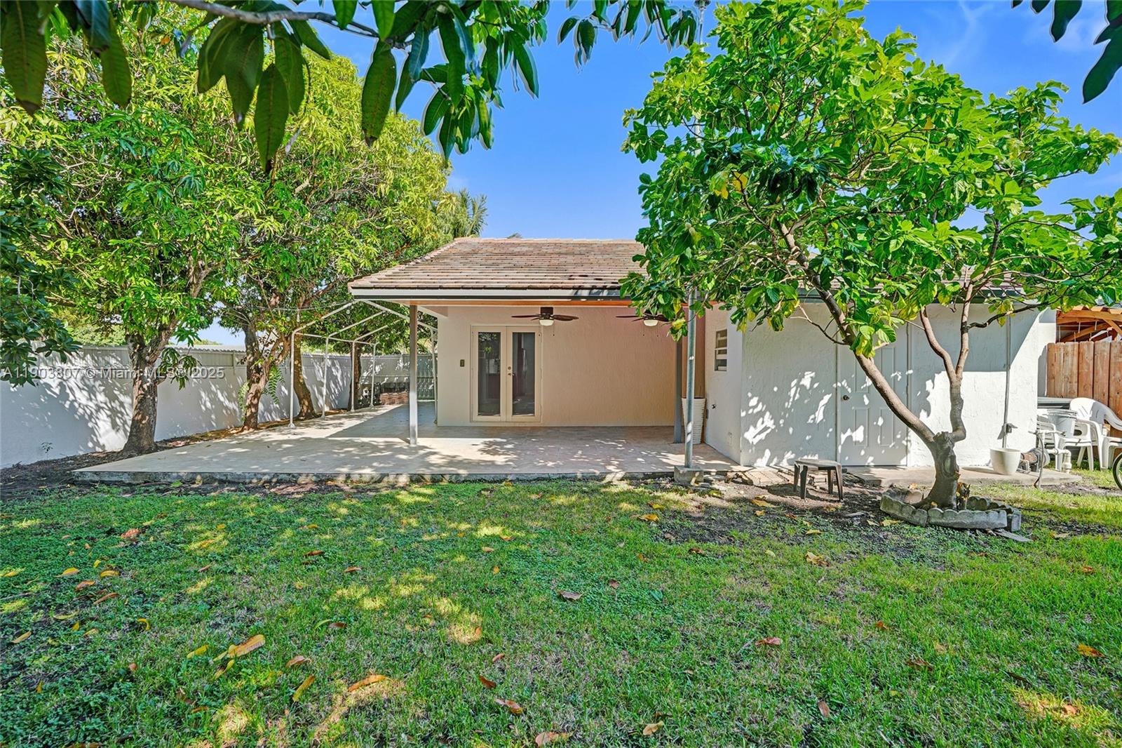 11482 Southwest 181st Street Miami, FL 33157 - Photo 28 of 35 a view of a house with backyard sitting area and garden