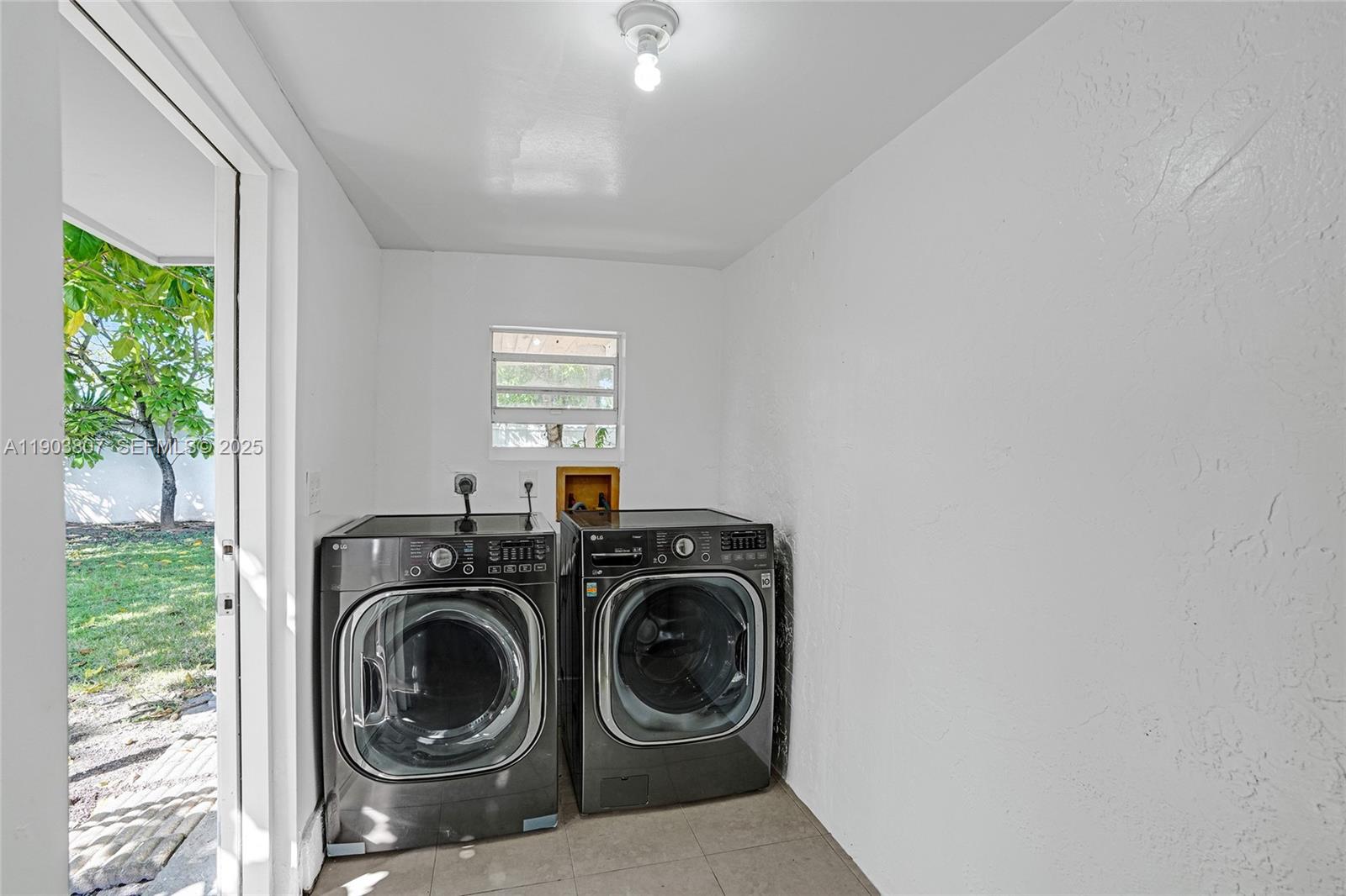 11482 Southwest 181st Street Miami, FL 33157 - Photo 30 of 35 a utility room with sink dryer and washer