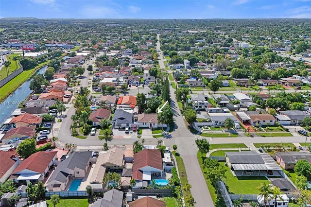 an aerial view of residential houses with outdoor space and street view