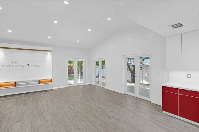 a view of empty room with wooden floor