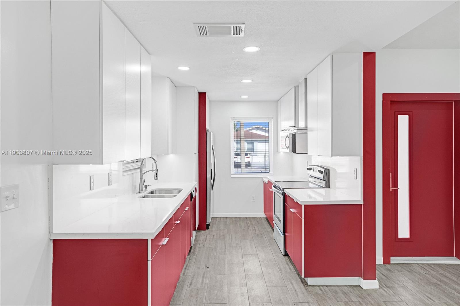 11482 Southwest 181st Street Miami, FL 33157 - Photo 7 of 35 a kitchen with kitchen island granite countertop a sink a counter top space and stainless steel appliances