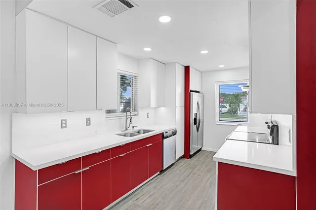 a kitchen with a sink a stove and a refrigerator