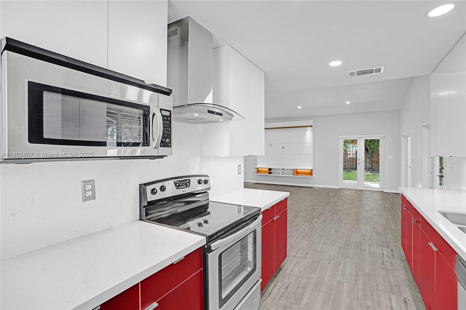 11482 Southwest 181st Street Miami, FL 33157 - Photo 9 of 35 a kitchen with a stove and a microwave