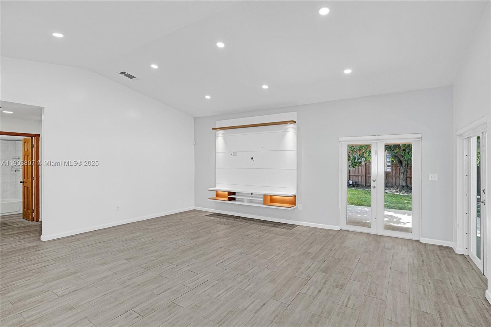 11482 Southwest 181st Street Miami, FL 33157 - Photo 10 of 35 an empty room with wooden floor and window