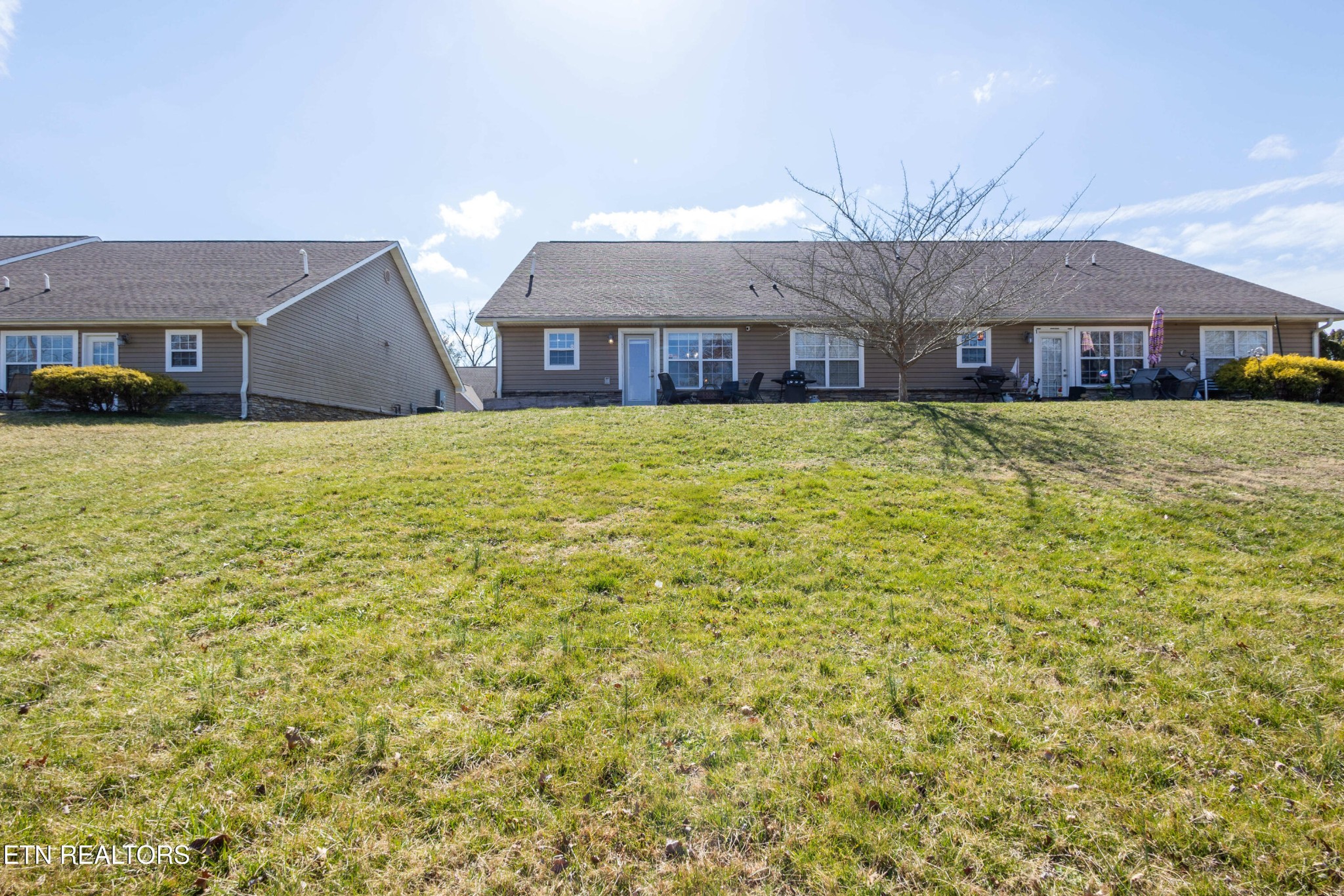 342 Meriwether Way Sevierville, TN 37863 - Photo 21 of 21 a brick house with a big yard and large trees