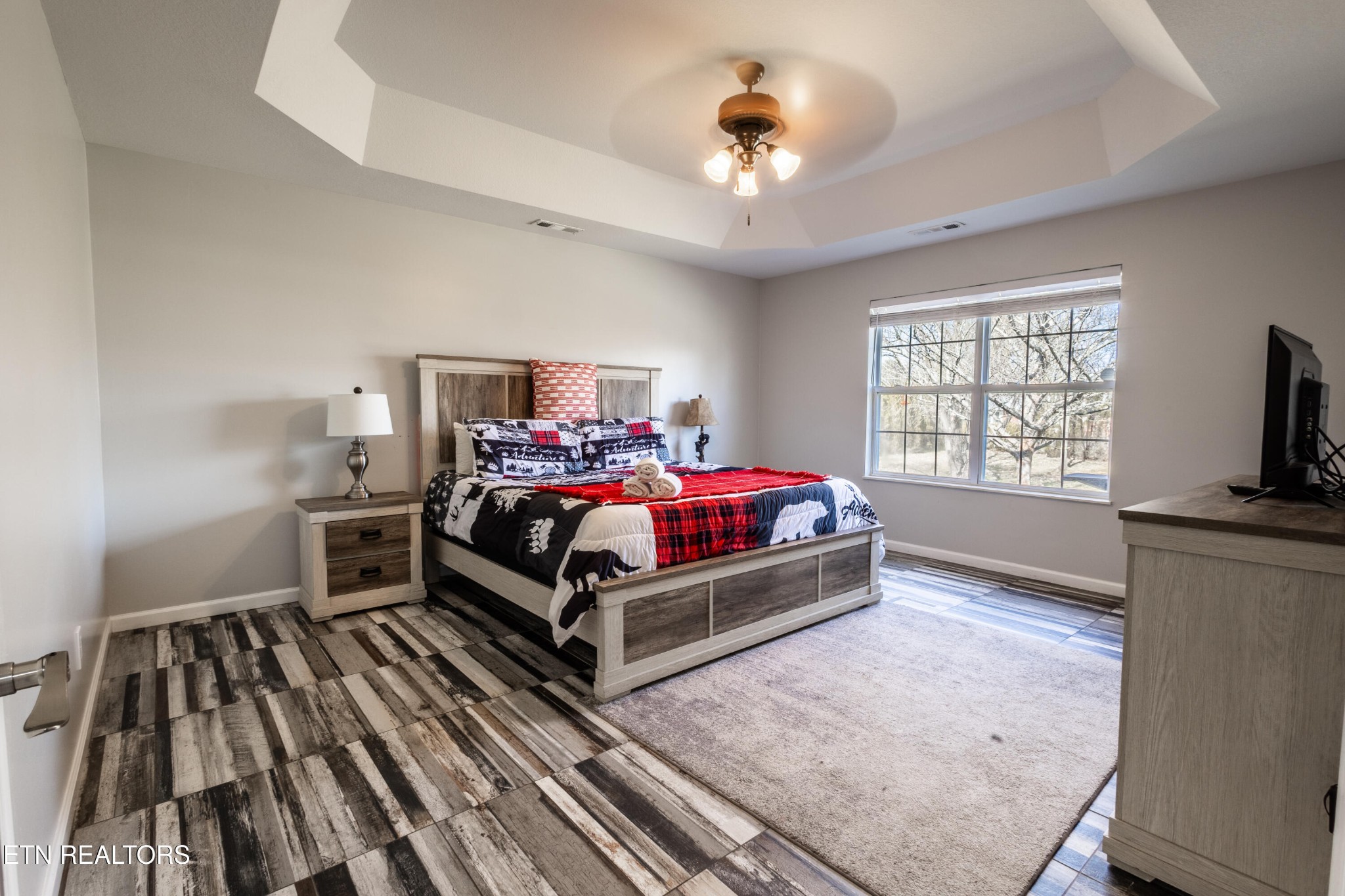 342 Meriwether Way Sevierville, TN 37863 - Photo 6 of 21 a bedroom with a bed and a flat tv screen on a dresser