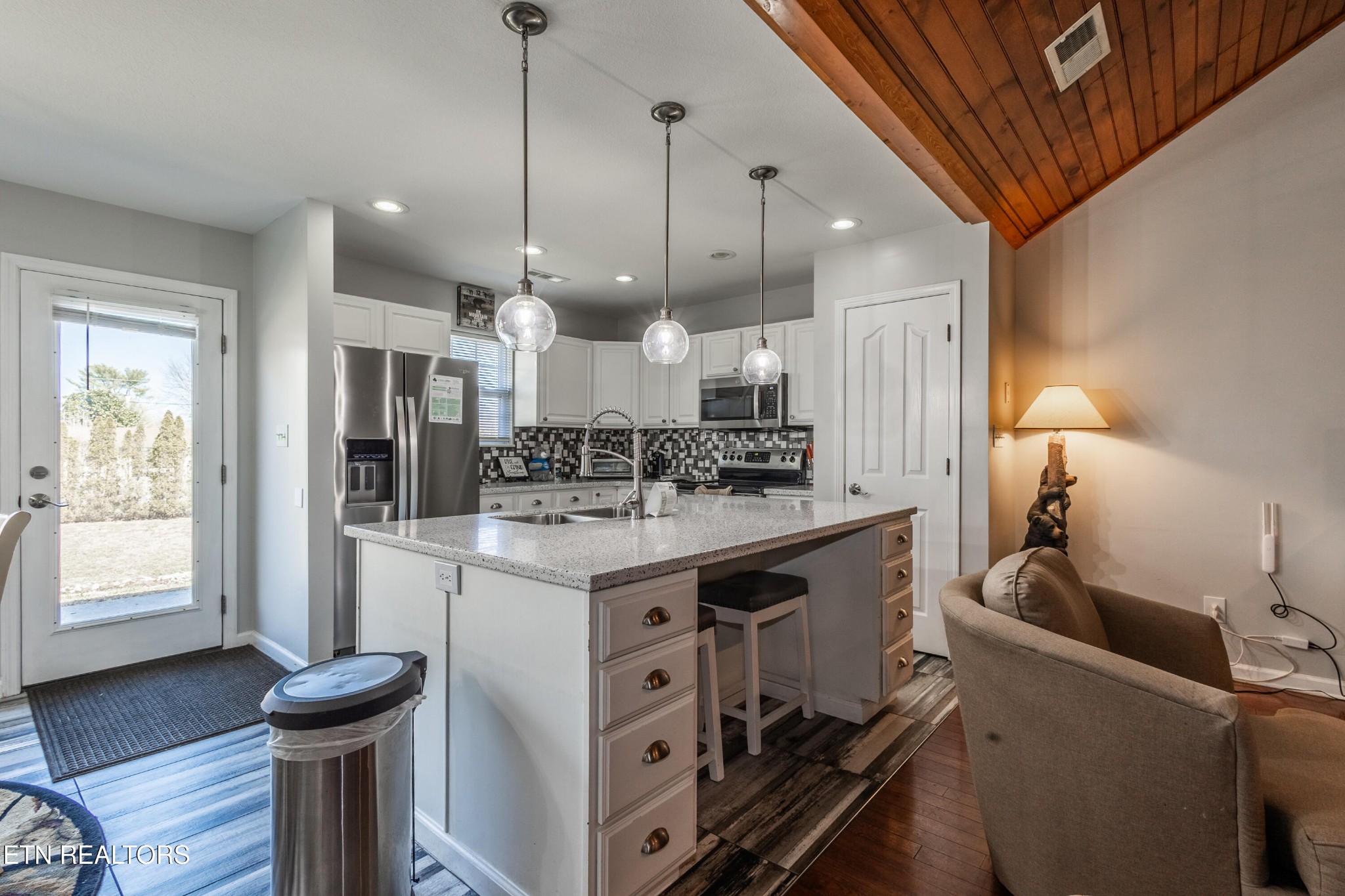 342 Meriwether Way Sevierville, TN 37863 - Photo 7 of 21 a kitchen with kitchen island a stove a refrigerator a sink dishwasher with a dining table and chairs