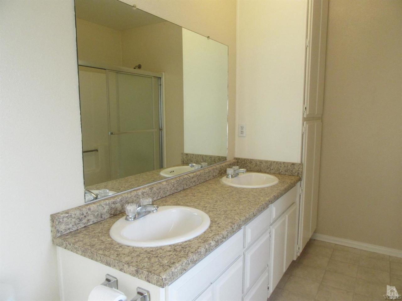 509 Drown Avenue Ojai, CA 93023 - Photo 12 of 17 a bathroom with a granite countertop sink and a mirror