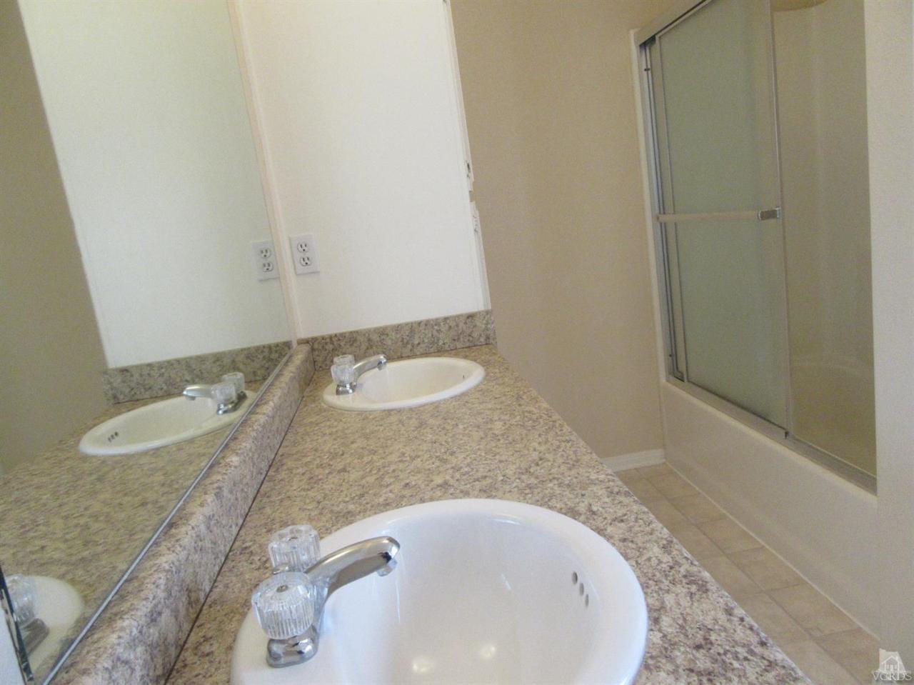 509 Drown Avenue Ojai, CA 93023 - Photo 13 of 17 a bathroom with a granite countertop sink and a mirror