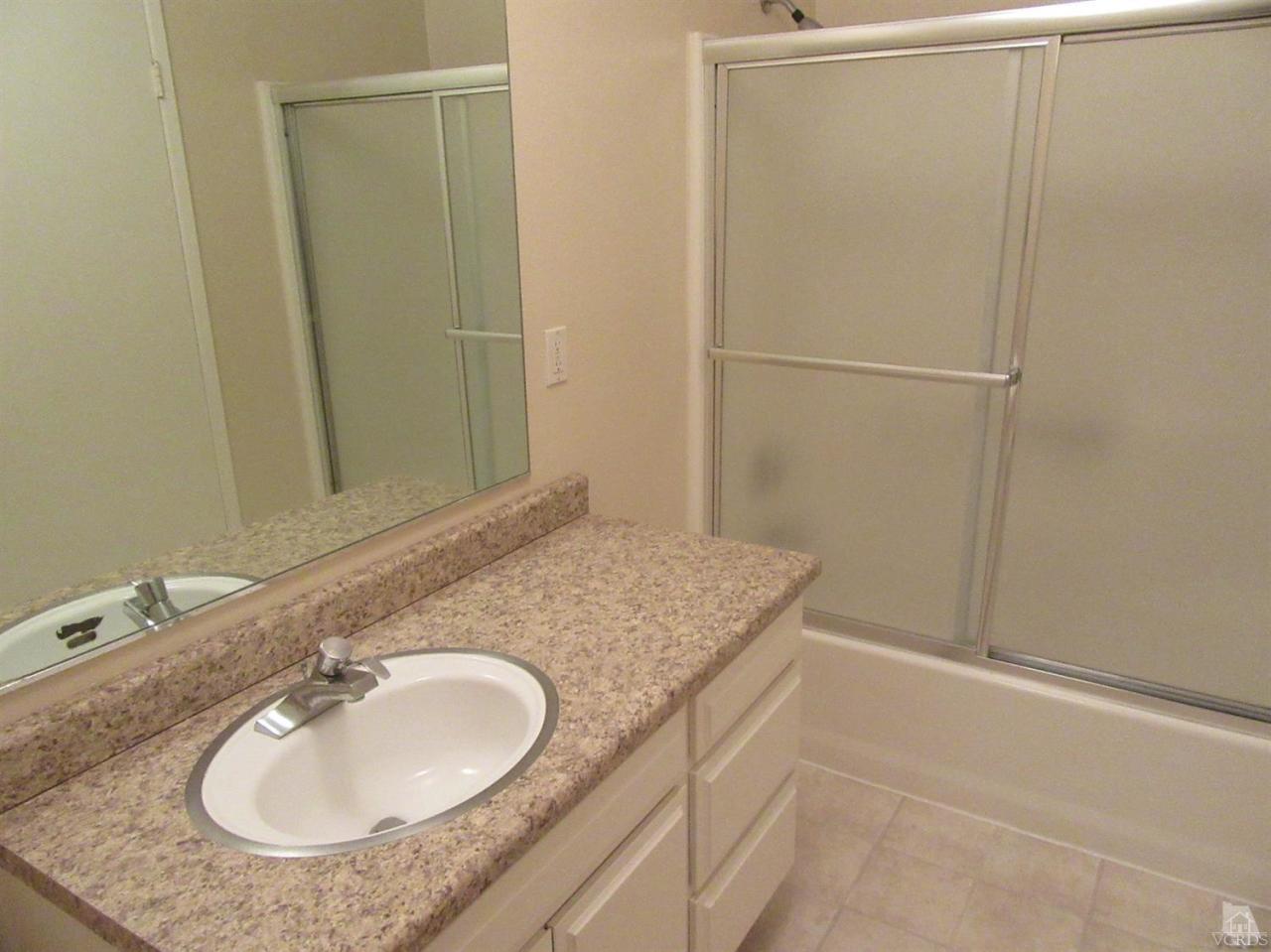 509 Drown Avenue Ojai, CA 93023 - Photo 8 of 17 a bathroom with a granite countertop sink and a mirror