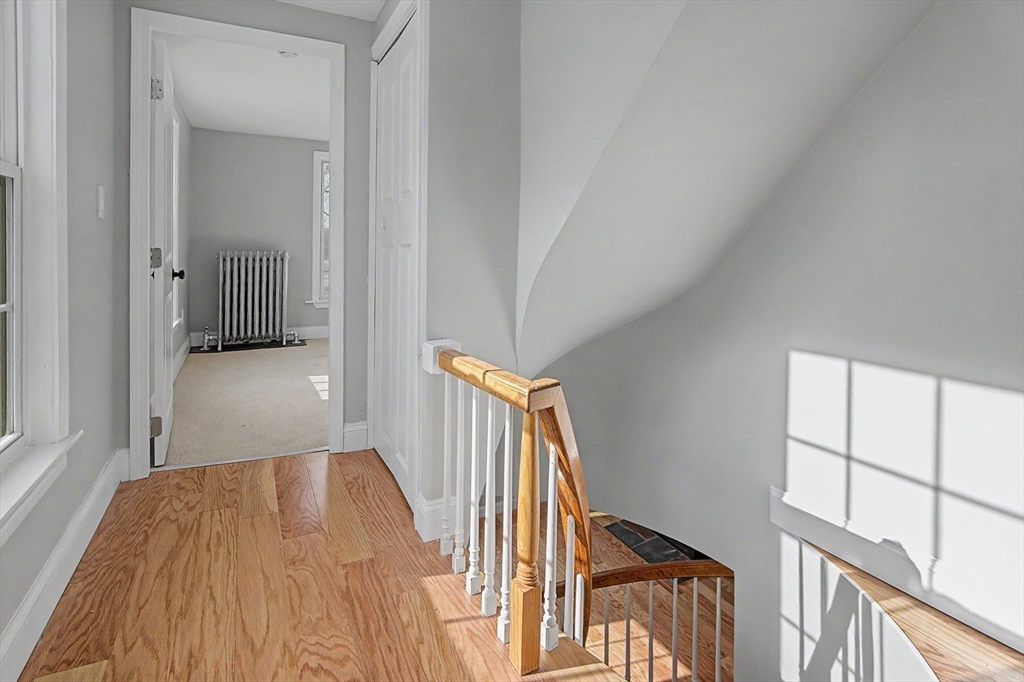 122 Chapin Road Hudson, MA 01749 - Photo 11 of 20 a view of a hallway with wooden floor and stairs