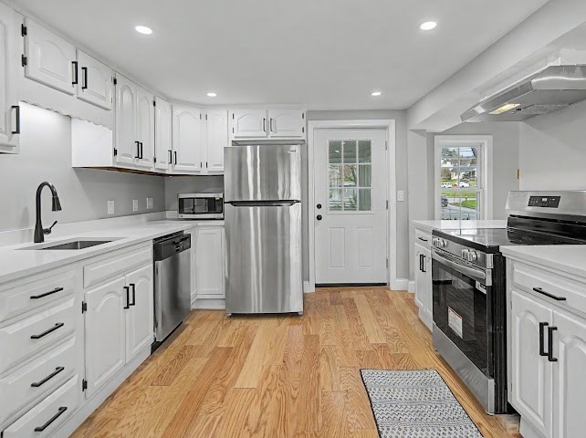 122 Chapin Road Hudson, MA 01749 - Photo 3 of 20 a kitchen with white cabinets and stainless steel appliances