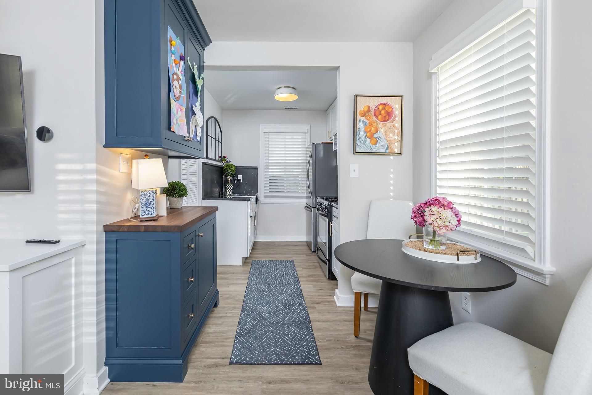 225 Spruce Street Haddonfield, NJ 08033 - Photo 13 of 28 a kitchen with stainless steel appliances wooden floor and dining table