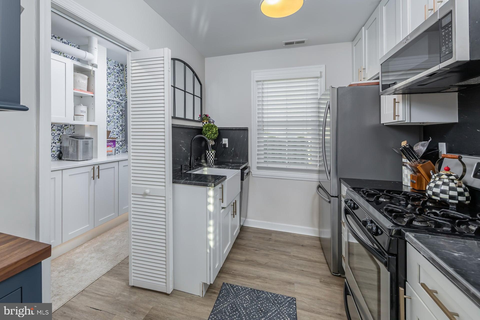 225 Spruce Street Haddonfield, NJ 08033 - Photo 17 of 28 a kitchen with stainless steel appliances kitchen island wooden cabinets and a stove