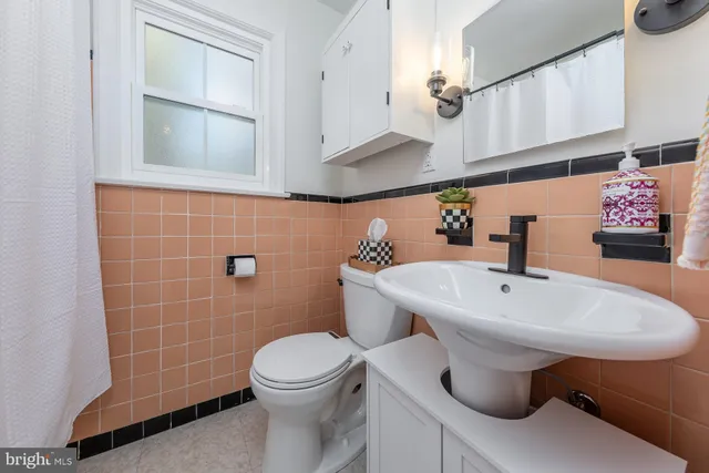 a bathroom with a sink a toilet and mirror